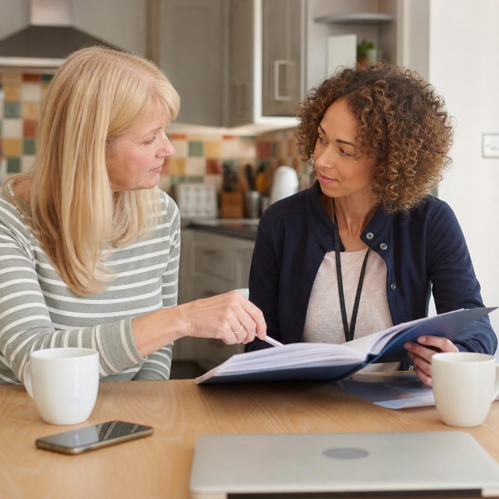 Foster parent and respite carer discussing a child's care notes