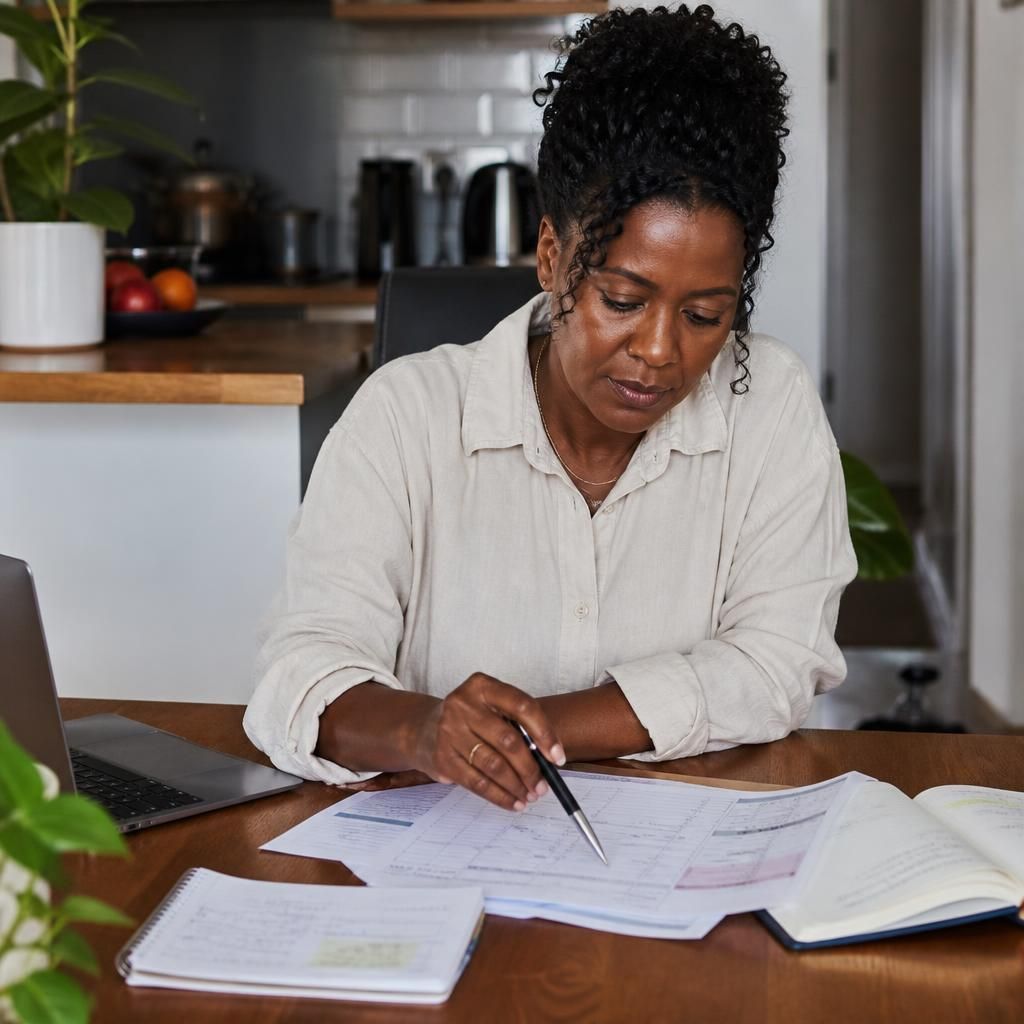 Foster carer reviewing placement dates and payment notes at a desk